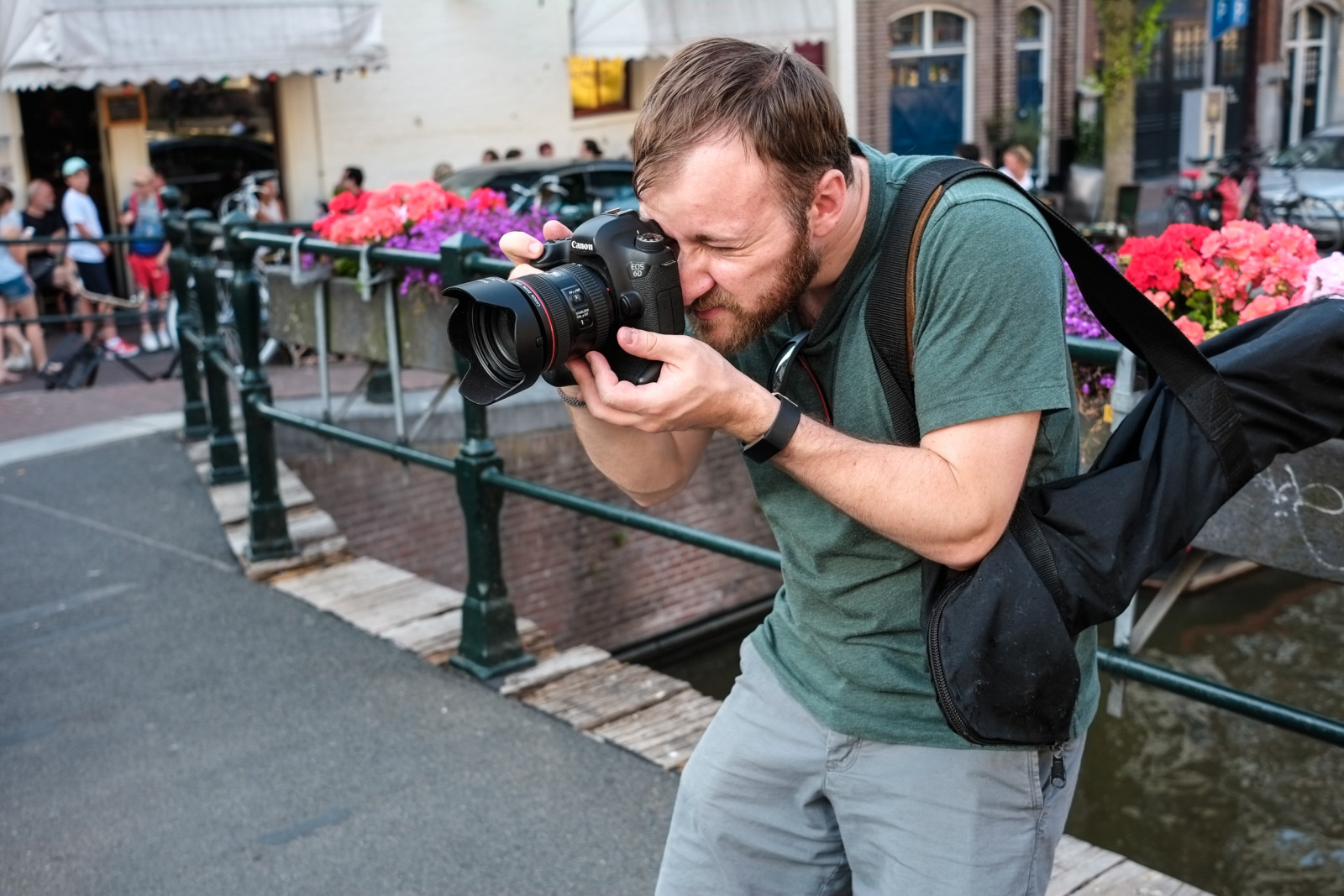 Amsterdam Photo guy photographing from bridge