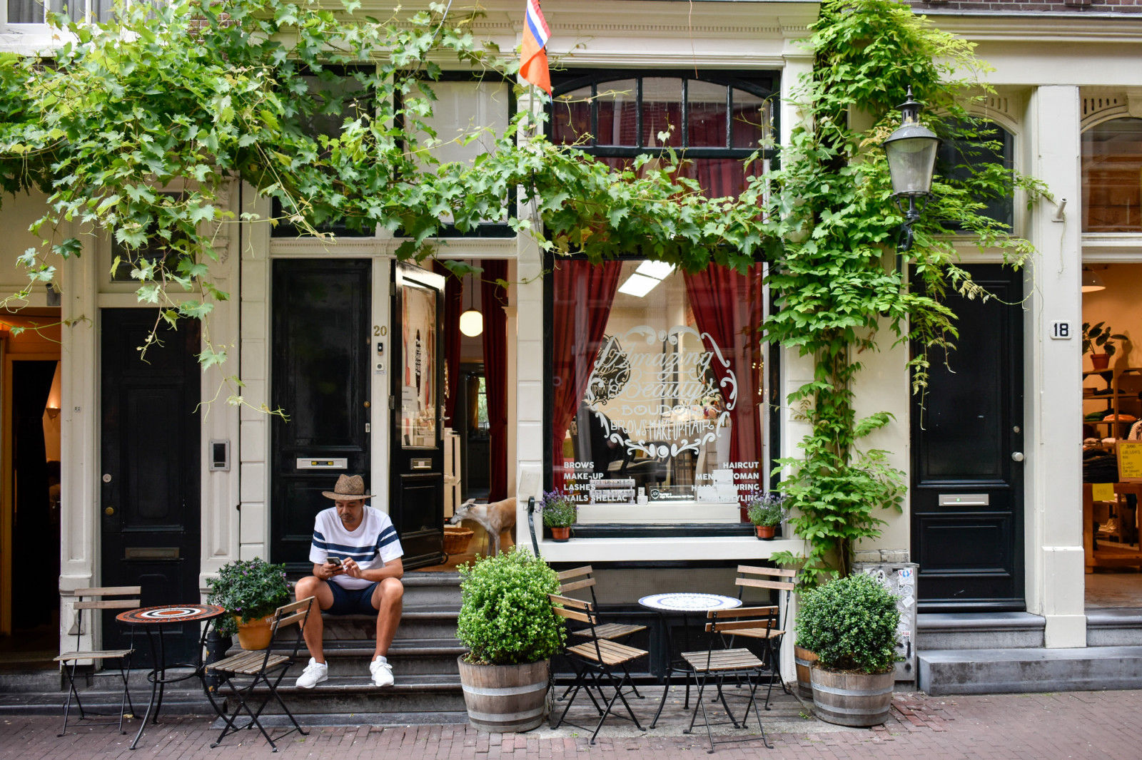 Guy sitting at doorsteps Amsterdam jordaan