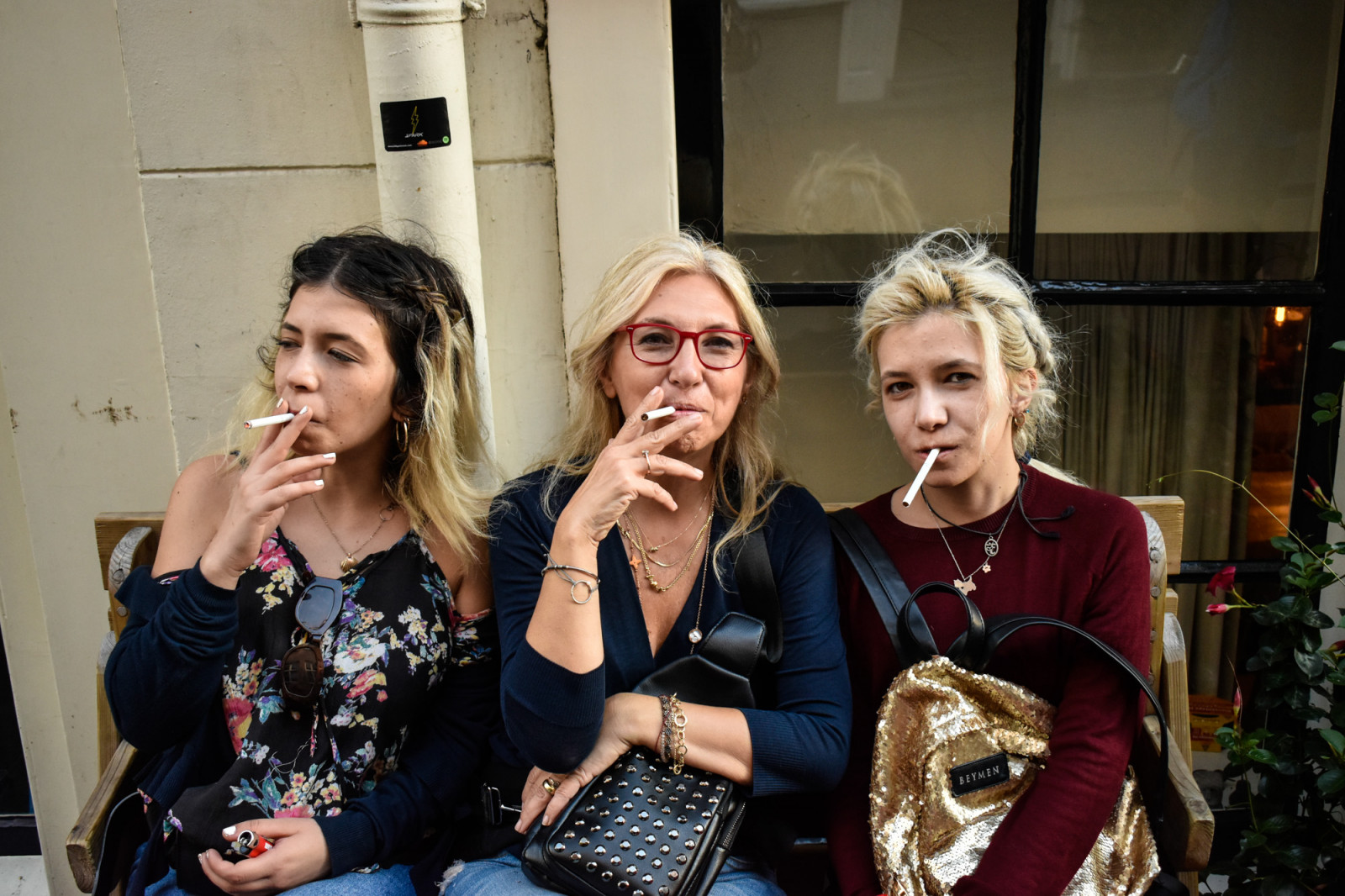 Three women smoking cigarettes in Amsterdam