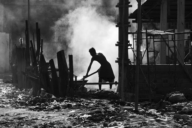 Phnom Penh slums man at work